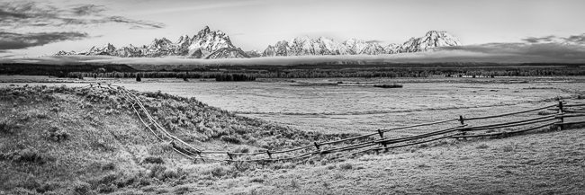 Dawn breaks on the Grand Tetons across the grasses of Triangle X Ranch.